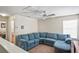 Cozy upper loft with a comfortable blue sectional sofa, perfect for relaxing at 3042 Gianna Way, Land O Lakes, FL 34638