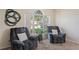 Comfortable living room featuring two plush reclining chairs and a large arched window with natural light at 3042 Gianna Way, Land O Lakes, FL 34638