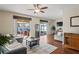 Open living room features wood floors, comfortable seating, and glass doors to the outdoor patio at 3042 Gianna Way, Land O Lakes, FL 34638
