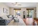 Spacious living room boasts natural light, sleek furniture, and access to the outdoor patio at 3042 Gianna Way, Land O Lakes, FL 34638