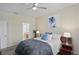 Cozy main bedroom features a ceiling fan and seamless transition to the bathroom at 3042 Gianna Way, Land O Lakes, FL 34638