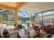 Inviting screened patio with comfortable seating and pool view at 3042 Gianna Way, Land O Lakes, FL 34638