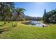 Scenic pond view showcases lush landscaping and tranquil waters, enhancing the property's natural beauty at 3042 Gianna Way, Land O Lakes, FL 34638