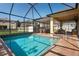 Beautiful in-ground pool with screened-in patio and seating area at 3042 Gianna Way, Land O Lakes, FL 34638