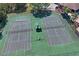 A stunning view of the community tennis courts with mature trees at 3042 Gianna Way, Land O Lakes, FL 34638