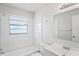 Bathroom featuring subway tiles in the shower and around the window at 3209 Kismet Ct, New Port Richey, FL 34655