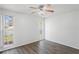 Well-lit bedroom featuring wood-look flooring and two windows at 3209 Kismet Ct, New Port Richey, FL 34655