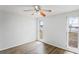Well-lit bedroom featuring wood-look flooring and two windows at 3209 Kismet Ct, New Port Richey, FL 34655