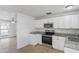 Well-lit kitchen featuring stainless steel appliances, granite counters and ample cabinet space at 3209 Kismet Ct, New Port Richey, FL 34655