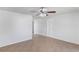 A bright living room featuring tile flooring and a modern ceiling fan at 3209 Kismet Ct, New Port Richey, FL 34655