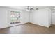 Open living area with tile floors, ceiling fan, and a large picture window at 3209 Kismet Ct, New Port Richey, FL 34655