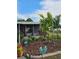 Charming home with a landscaped front yard, potted plants, and an ADT security sign at 36312 Toranado Way, Zephyrhills, FL 33541