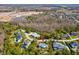 Aerial view of the property showcases its location in a wooded area with a private pool at 3733 Wiregrass Rd, New Port Richey, FL 34655