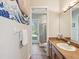 Bathroom with tiled floors and shower and sink with brown wooden vanity at 3733 Wiregrass Rd, New Port Richey, FL 34655