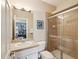 This bathroom features a glass shower enclosure and a vanity with modern fixtures at 3733 Wiregrass Rd, New Port Richey, FL 34655