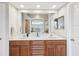 Bright bathroom featuring double vanity with wood cabinets and luxurious marble countertops at 3733 Wiregrass Rd, New Port Richey, FL 34655
