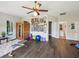 A spacious bonus room offering wood laminate floors, a sauna, and direct access to the attached bathroom at 3733 Wiregrass Rd, New Port Richey, FL 34655