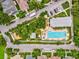 Aerial view of the community pool, showcasing its amenities, landscaping and surrounding neighborhood at 3733 Wiregrass Rd, New Port Richey, FL 34655