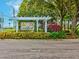 Community entrance sign with lush landscaping and neighborhood branding features at 3733 Wiregrass Rd, New Port Richey, FL 34655