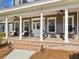 Inviting front porch with brick accents, stylish seating, and ceiling fans for added comfort at 3733 Wiregrass Rd, New Port Richey, FL 34655