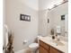 A cozy half-bathroom featuring modern fixtures, a marble vanity, and a decorative framed picture at 3733 Wiregrass Rd, New Port Richey, FL 34655