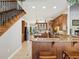 Open concept kitchen with dark wood cabinetry, granite countertops, and breakfast bar for casual dining at 3733 Wiregrass Rd, New Port Richey, FL 34655