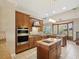 Spacious kitchen featuring granite countertops, custom cabinetry, and stainless appliances at 3733 Wiregrass Rd, New Port Richey, FL 34655