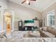 Bright living room featuring a fireplace, plush sofa, and vaulted ceiling at 3733 Wiregrass Rd, New Port Richey, FL 34655