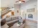 Spacious living room featuring a cozy fireplace, high ceilings, and comfortable seating at 3733 Wiregrass Rd, New Port Richey, FL 34655