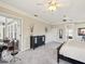 Spacious main bedroom with dark furniture, ceiling fans, and outdoor access at 3733 Wiregrass Rd, New Port Richey, FL 34655