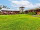 Community market offering local produce and goods with lush green landscaping and outdoor seating at 3733 Wiregrass Rd, New Port Richey, FL 34655