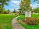 Manatee common Rawling Square park features a playground surrounded by lush landscaping and walking paths at 3733 Wiregrass Rd, New Port Richey, FL 34655