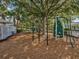 Charming playground area with climbing structure, swings, and slide, perfect for neighborhood children to enjoy at 3733 Wiregrass Rd, New Port Richey, FL 34655