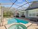 Backyard pool with spa and screened lanai that has outdoor lounge and dining spaces at 3733 Wiregrass Rd, New Port Richey, FL 34655