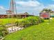Exterior shot of Starkey Market, a country-style restaurant with outdoor seating and windmill at 3733 Wiregrass Rd, New Port Richey, FL 34655