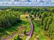 Scenic aerial view of the community walking path, surrounded by lush greenery and mature trees at 3733 Wiregrass Rd, New Port Richey, FL 34655