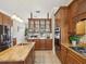 Spacious kitchen featuring custom wood cabinets, granite countertops, and stainless steel appliances at 3733 Wiregrass Rd, Trinity, FL 34655