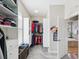 Walk-in closet with custom storage, shelving, and natural light from the window at 3733 Wiregrass Rd, New Port Richey, FL 34655