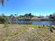 Backyard features lush tropical landscaping and seating area overlooking a waterway at 4030 Grayton Dr, New Port Richey, FL 34652