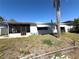 Home's backyard featuring a screened patio at 4030 Grayton Dr, New Port Richey, FL 34652