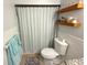 Bathroom with a shower curtain and wooden shelving at 4030 Grayton Dr, New Port Richey, FL 34652