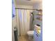 Bright bathroom featuring a shower with a white curtain and tiled walls and floors at 4030 Grayton Dr, New Port Richey, FL 34652