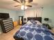Relaxing bedroom with ceiling fan, dresser, and tiled floors at 4030 Grayton Dr, New Port Richey, FL 34652