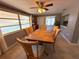Inviting dining room featuring wood table, seating for six, and view to the screened porch at 4030 Grayton Dr, New Port Richey, FL 34652