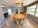 Dining area featuring tile floors, a ceiling fan, and a wooden dining table with seating for six at 4030 Grayton Dr, New Port Richey, FL 34652
