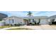 Single-story home features a stone facade, attached garage, and well-maintained landscaping at 4030 Grayton Dr, New Port Richey, FL 34652