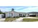 Single-story home with stone facade, attached garage, and manicured landscaping at 4030 Grayton Dr, New Port Richey, FL 34652