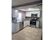 Bright kitchen featuring stainless steel appliances, stone countertops and light-colored cabinetry at 4030 Grayton Dr, New Port Richey, FL 34652