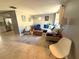 Comfortable living room with tile floors, area rug, a sofa, rocking chair and lamps at 4030 Grayton Dr, New Port Richey, FL 34652