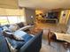 Comfortable living room featuring a corner sectional, fireplace, tile floors, and natural light at 4030 Grayton Dr, New Port Richey, FL 34652